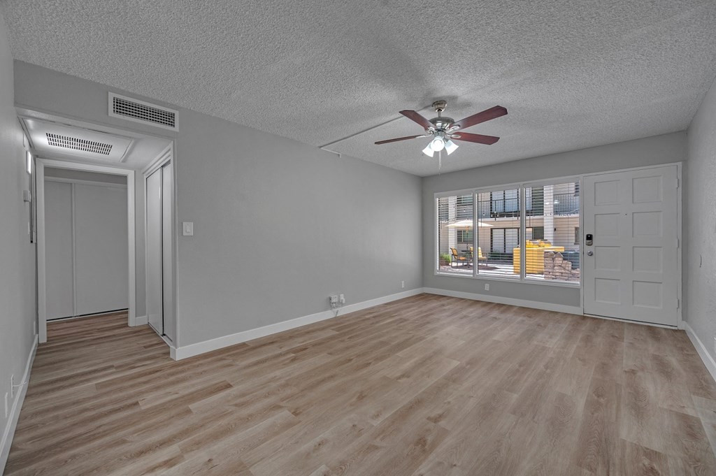a bedroom with hardwood floors and a ceiling fan