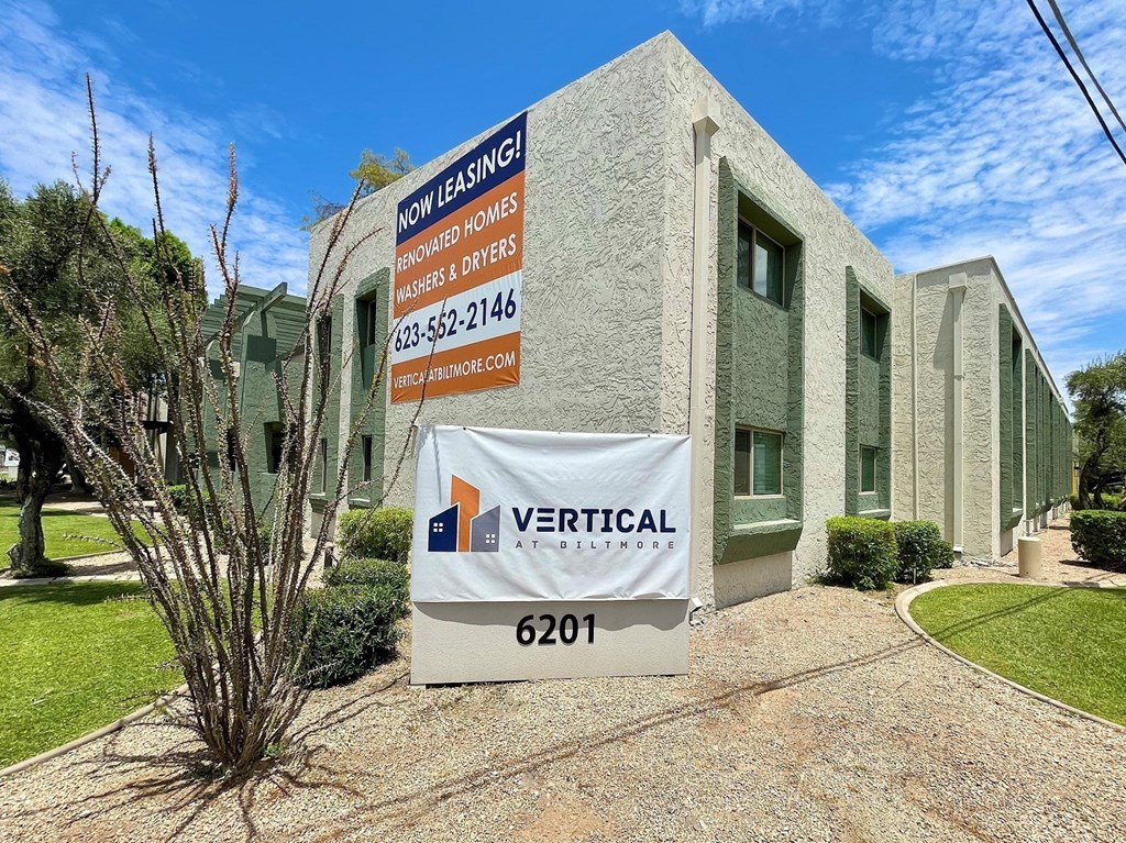 a building with a vertical sign in front of it