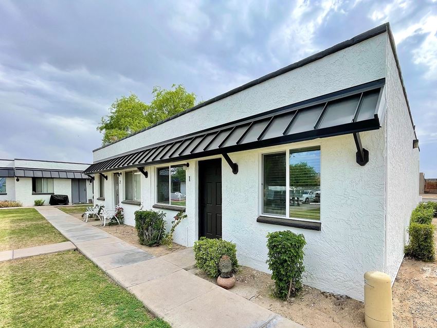 a white building with a black awning - Photo Gallery