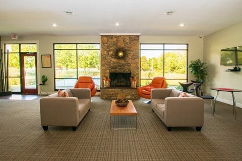 a living room with couches and chairs and a fireplace