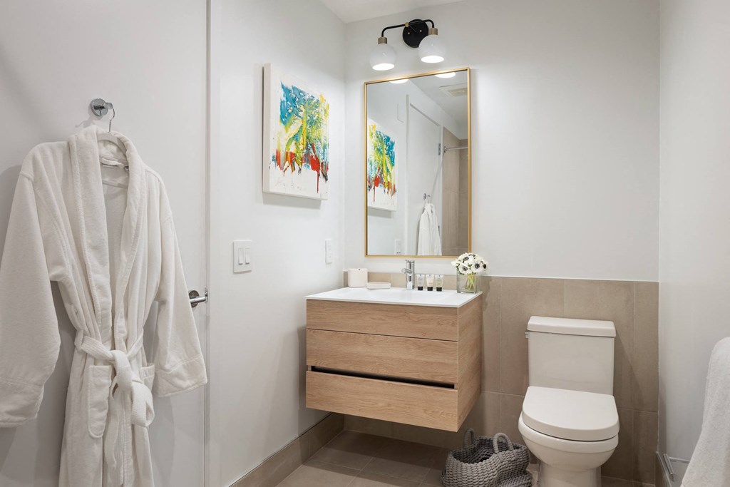 a bathroom with a toilet sink and a mirror
