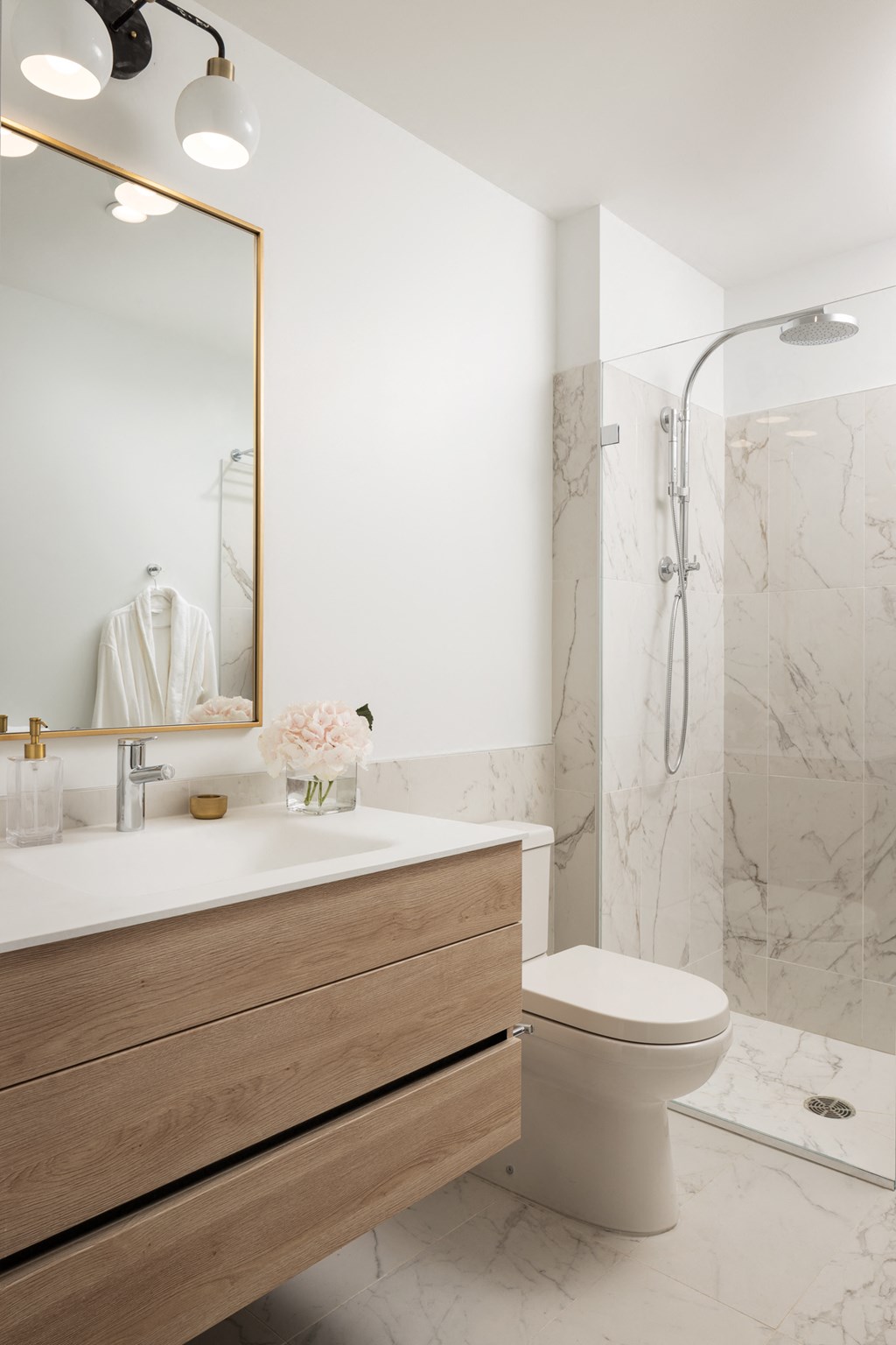 a bathroom with a toilet and a sink and a shower