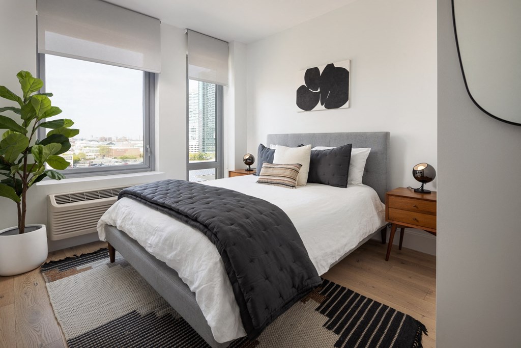 a bedroom with a large bed and a window