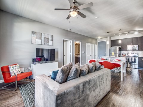 a living room with a couch and a ceiling fan