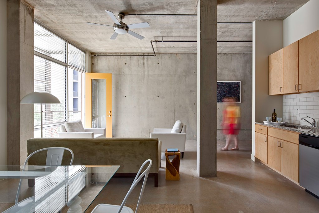 A modern kitchen with a dining table and chairs.