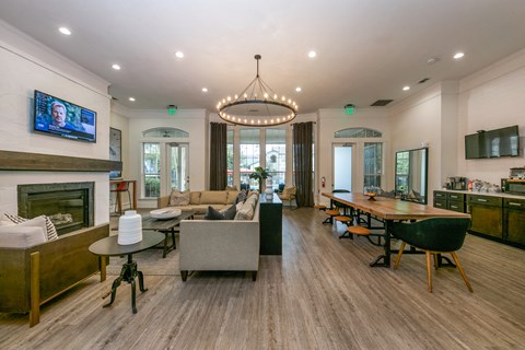 A modern living room with a fireplace and a television mounted on the wall.