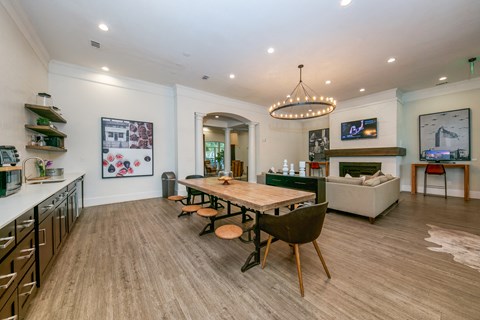 A modern kitchen with a dining table and chairs.