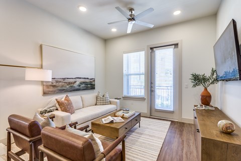 A living room with a brown leather chair and a white sofa.