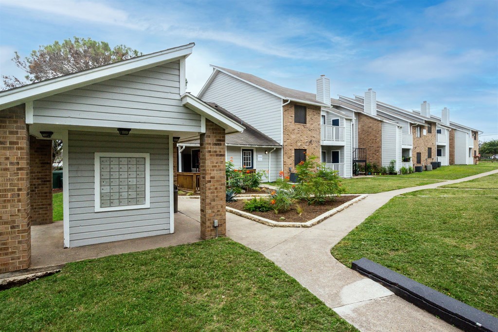 our apartments have a walkway to the street with grass at Northchase, Texas, 78753
