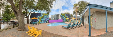 Swimming pool courtyard with covered pavilion and lounge seating at Azure Apartments, Austin, TX