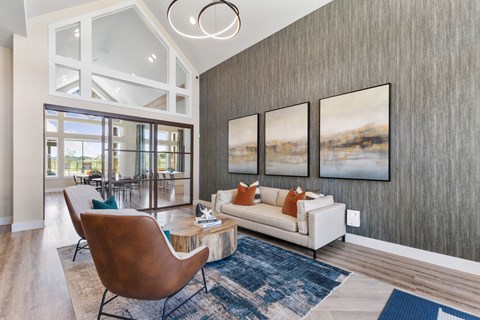 A modern living room with a white couch and a brown chair.