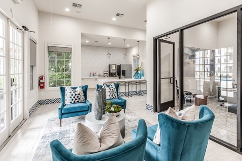 A living room with blue chairs and a white couch.