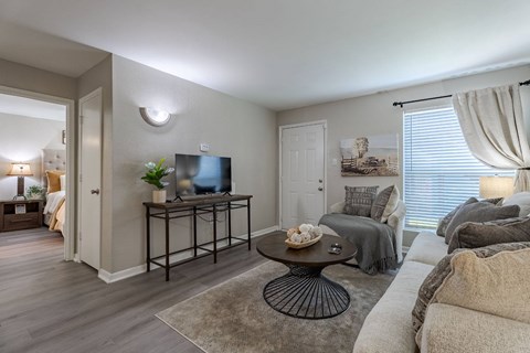 A living room with a grey couch and a coffee table.