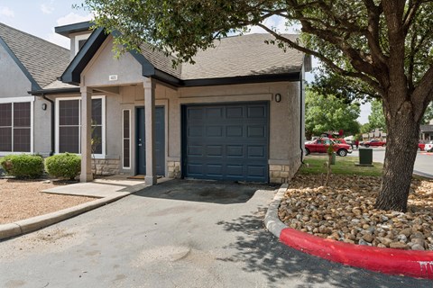 A house with a grey roof and a blue garage door.