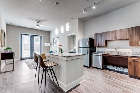 A modern kitchen with a dining table and chairs.
