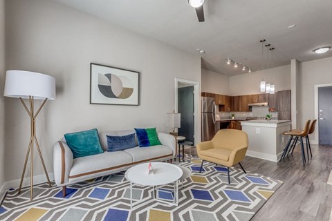 A living room with a white sofa and a yellow chair.