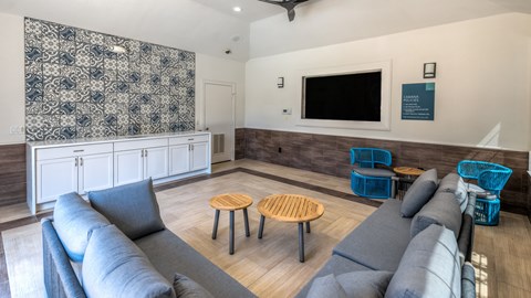 A living room with grey couches and a wooden coffee table.
