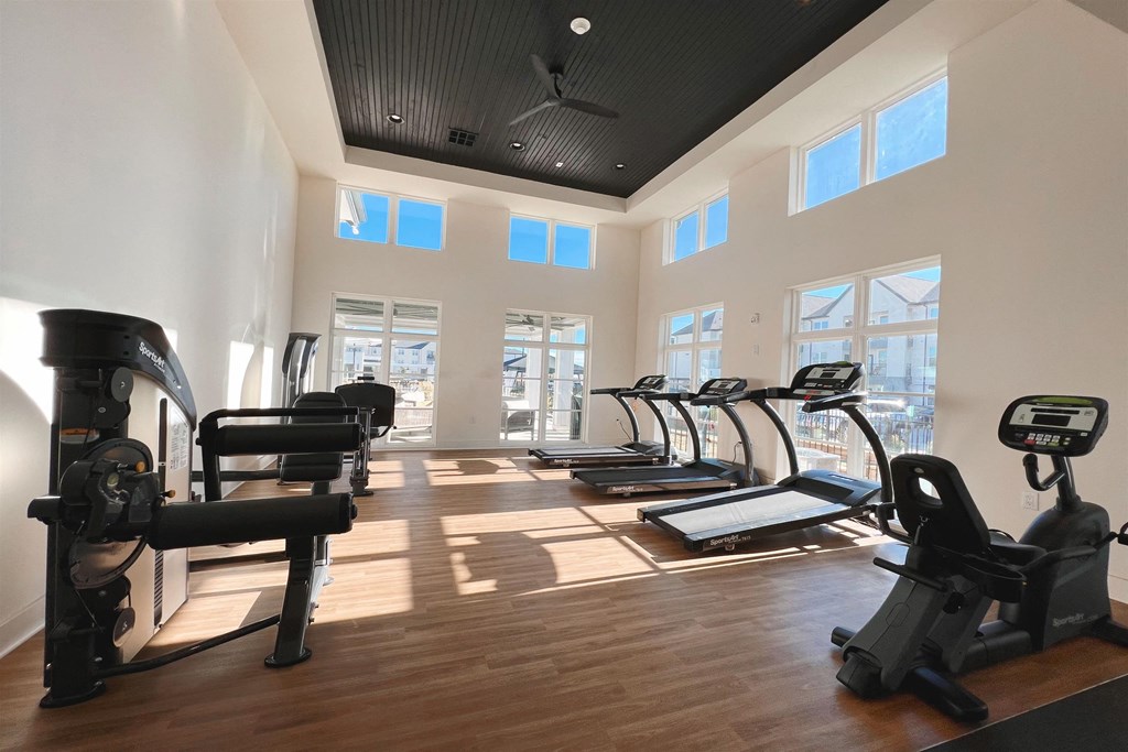 a gym with cardio equipment and windows in a building a gym with cardio equipment and windows in a building at The Fitzroy San Marcos, Texas