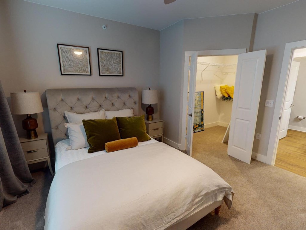 a bedroom with a large bed and a closet a bedroom with a large bed and a closet at The Fitzroy San Marcos, San Marcos, Texas
