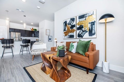 A living room with a brown couch and a coffee table.