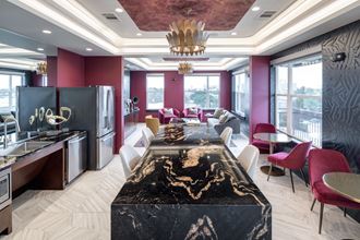 a kitchen and living room with a large table and chairs