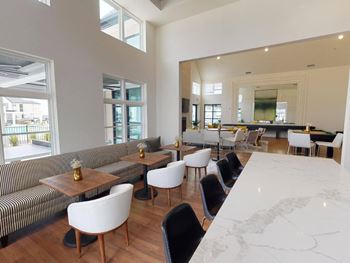 a large living room with tables and chairs and a counter at The Fitzroy San Marcos, San Marcos