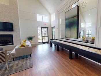 a large living room with a fireplace and a large mirror at The Fitzroy San Marcos, San Marcos, Texas