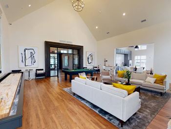 a living room with a couch and a pool table at The Fitzroy San Marcos, San Marcos, TX
