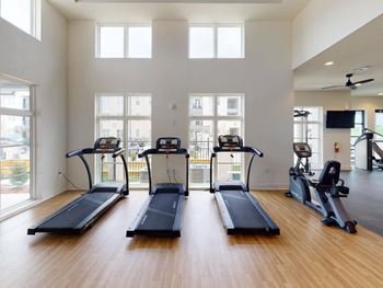 the gym is equipped with cardio equipment including treadmills at The Fitzroy San Marcos, Texas