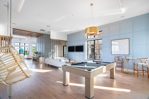Clubhouse lounge with pool table and seating at Hangar at Bergstrom Apartments, Texas, 78744