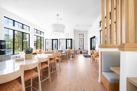 Bright communal dining space with wood furnishings at Hangar at Bergstrom Apartments, Austin, 78744
