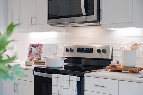 A modern kitchen with a black and white stove top.