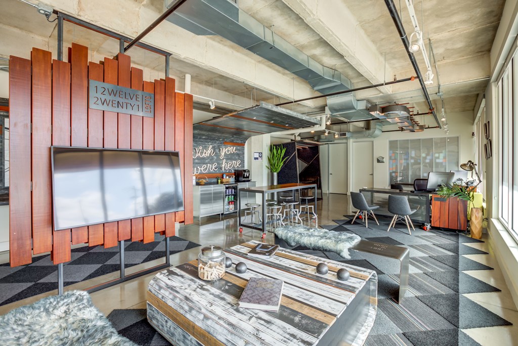 A modern office space with a wooden partition and a coffee table in the foreground.