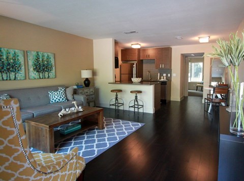 A living room with a brown sofa and a wooden coffee table.