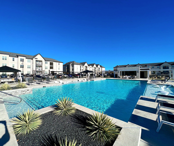 a large swimming pool in front of a building at The Fitzroy San Marcos, Texas