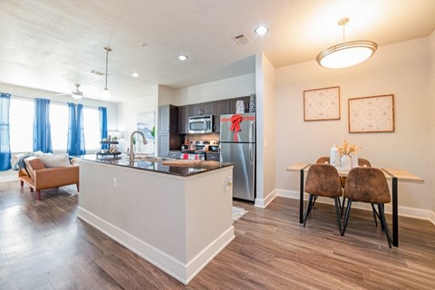 our apartments offer a living room with a fireplace and a dining area at The Landings at Brooks City-Base, Texas