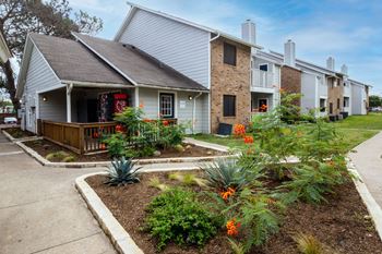 the front yard of a house with flowers and a sidewalk at Northchase, Austin