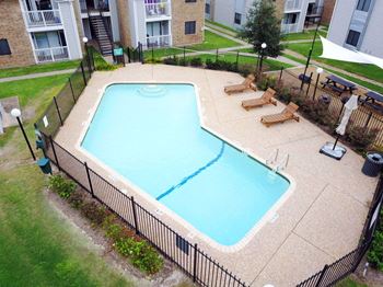 an aerial view of a swimming pool in front of an apartment building at Northchase, Austin, TX