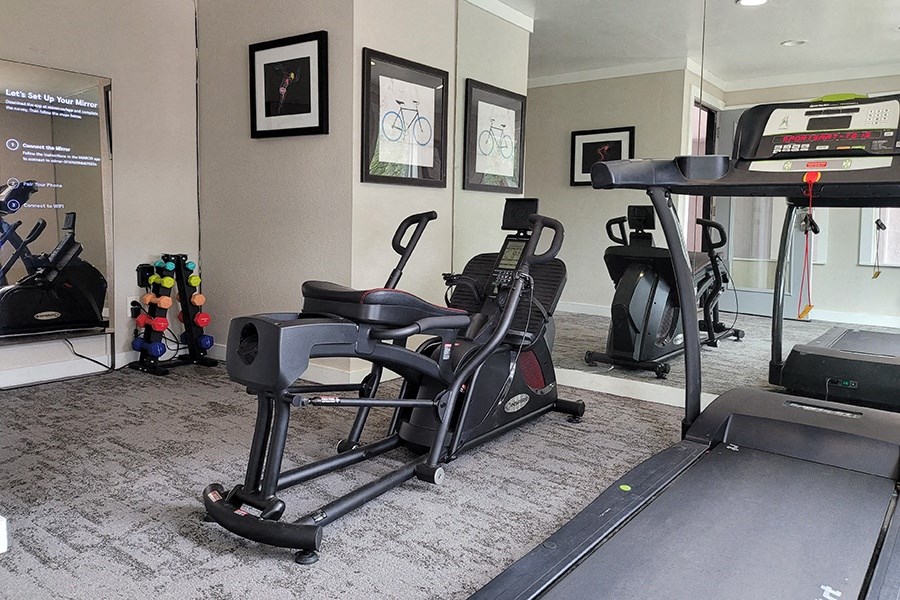a home gym with exercise equipment and a piano