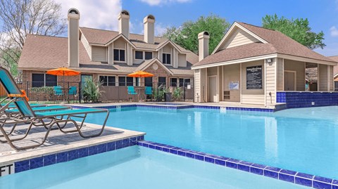 a swimming pool with chairs and a house in the background
