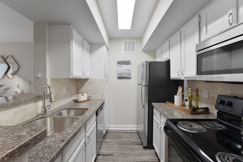 A kitchen with a black stove top oven.