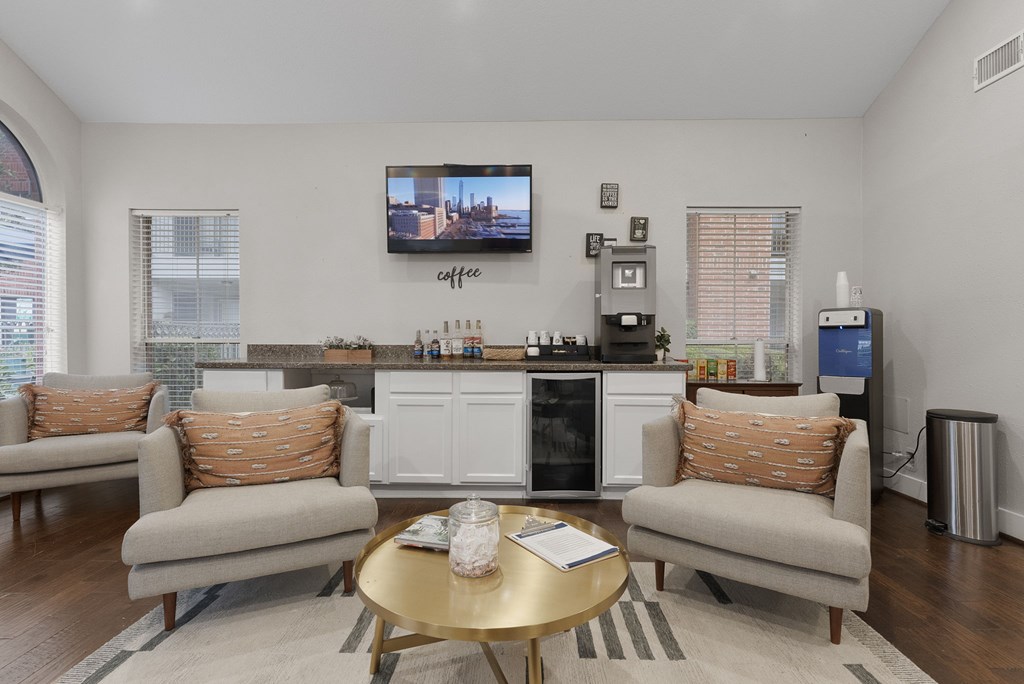A living room with a couch, a coffee table, and a television.