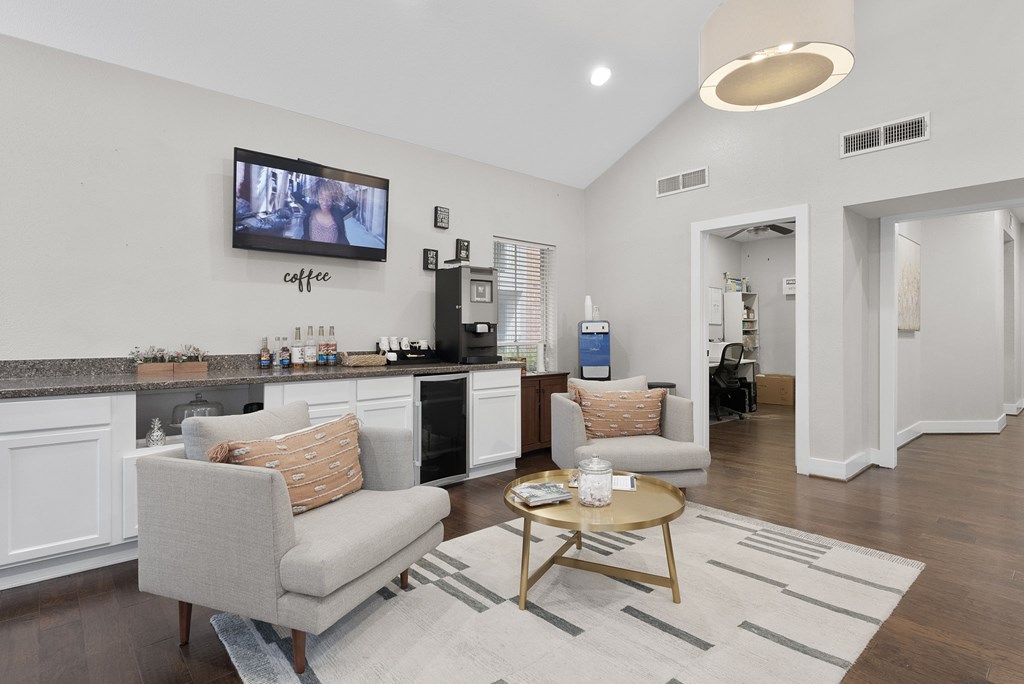 A living room with a grey couch and a coffee table.