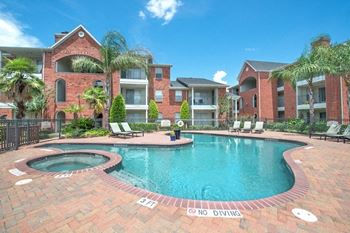 A pool surrounded by a brick border with a sign that says no diving.
