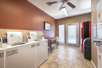 A laundry room with washers and dryers.