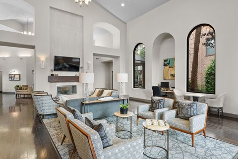 A living room with a grey carpet and furniture.