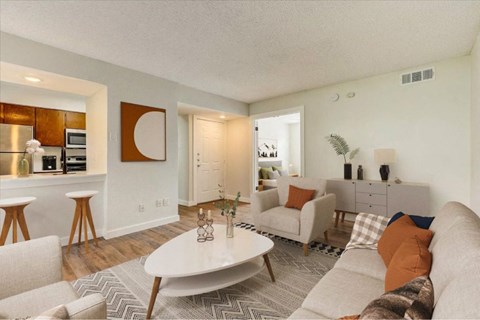 A living room with a white couch and a coffee table.