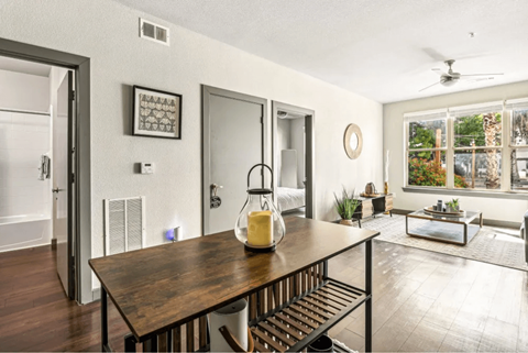 Open living space with dining table and seating at Lofts on Main Apartments, San Antonio