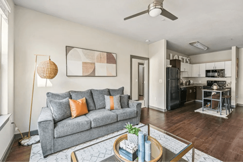 A living room with a grey couch and a coffee table.