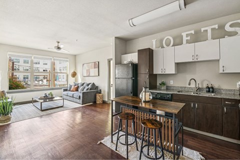 A kitchen with a bar stool in front of it.